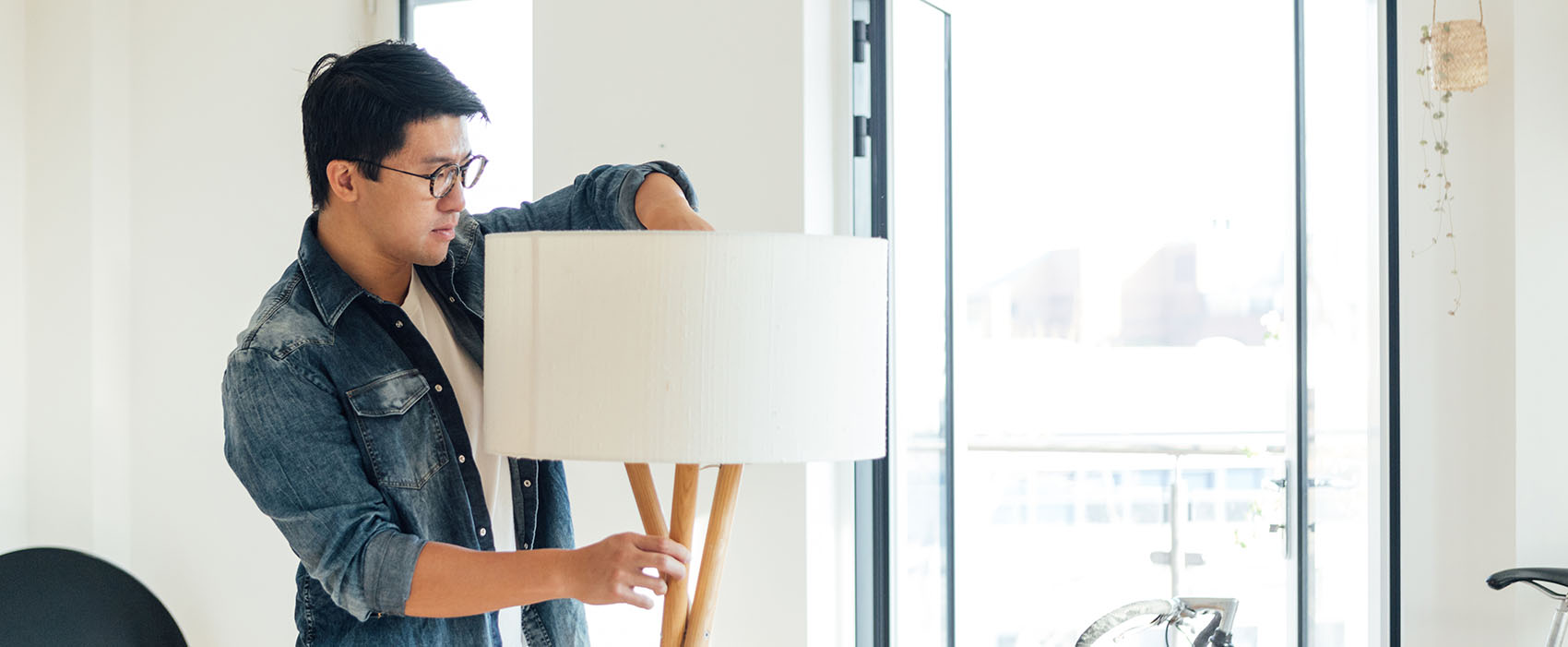 man fixing lightbulb at home