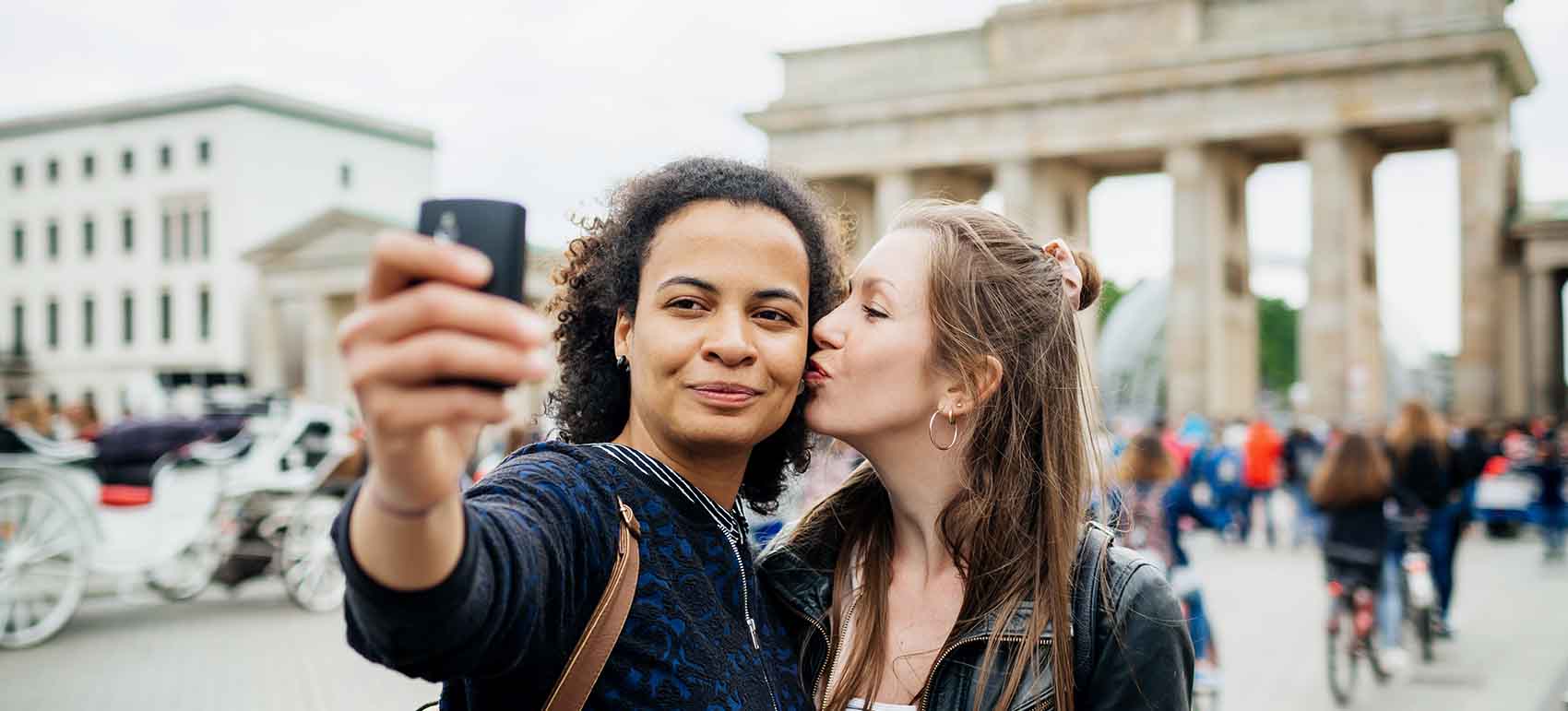 couple stop for a moment to take a selfie at a local historical site