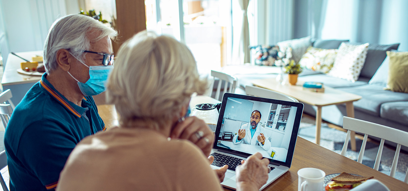 senior couple on video consultation with their doctor