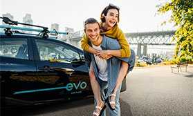 Evo members with Evo parked near bridge