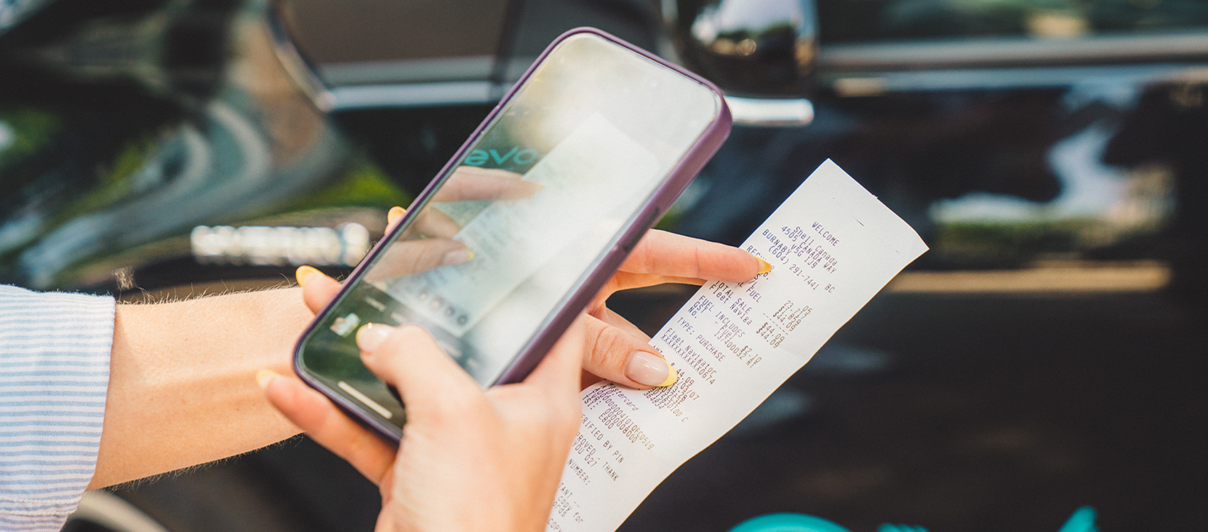 Scanning bill on smartphone next to an Evo vehicle