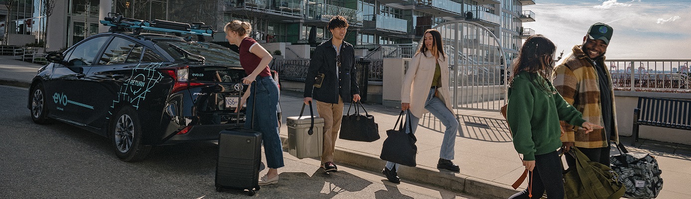 five people unloading an Evo Return vehicle