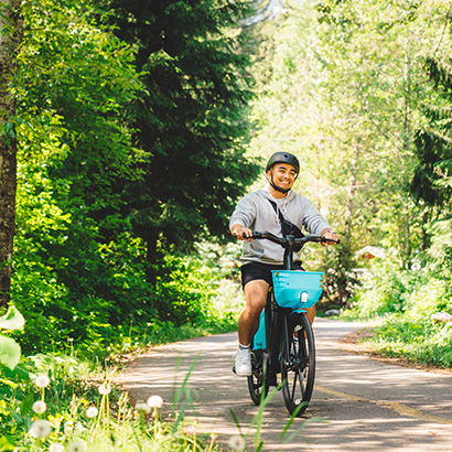Man riding e-bike through forest trail