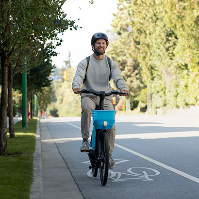Man riding an Evolve bike on a sunny day