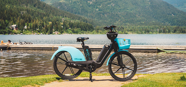 Evolve bike parked along with the scenic beach in the back
