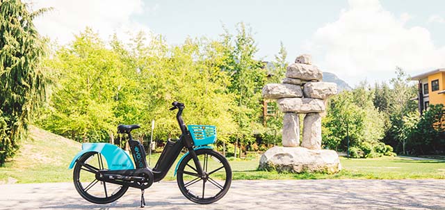 Evolve E-Bike parked near an inukshuk