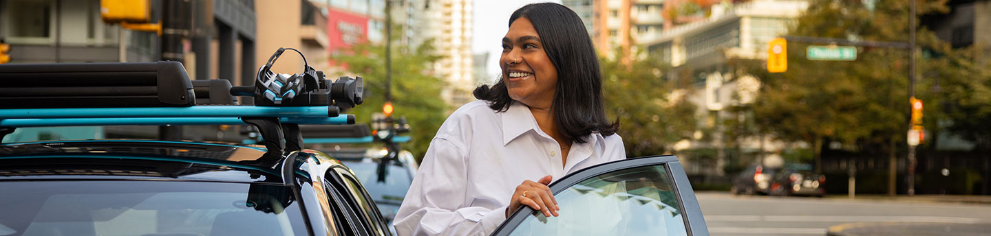 corporate woman stepping out of a shared Evo vehicle in the city
