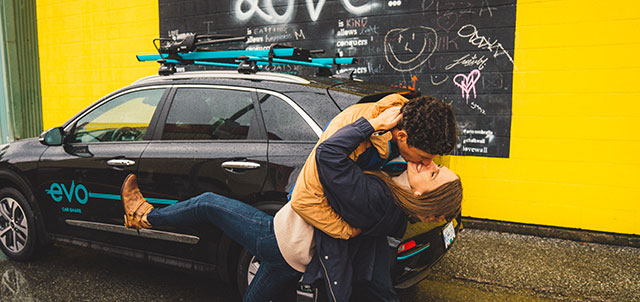 Happy couple dancing with an EVO car share